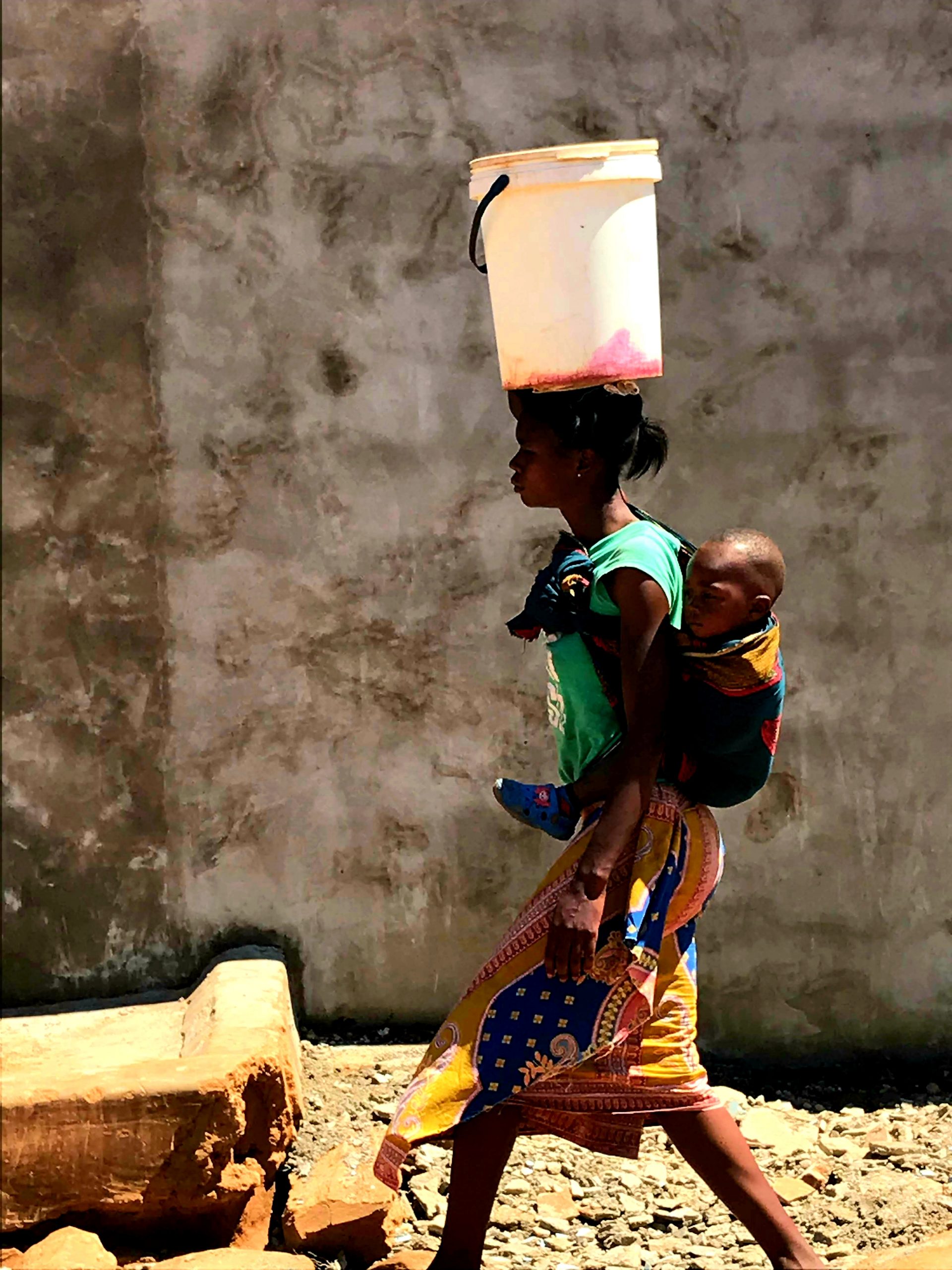 A woman walks in Jack Compound, Lusaka, Zambia.