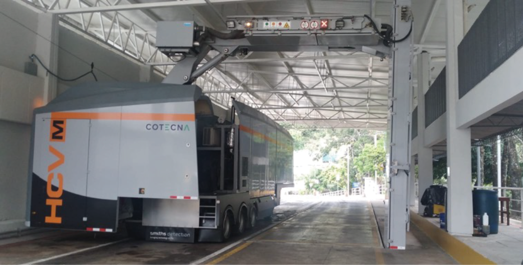 Foreground of photo shows integrated weighing machine. Customs booths have space for both El Salvador and Honduran Customs checks side-by-side.