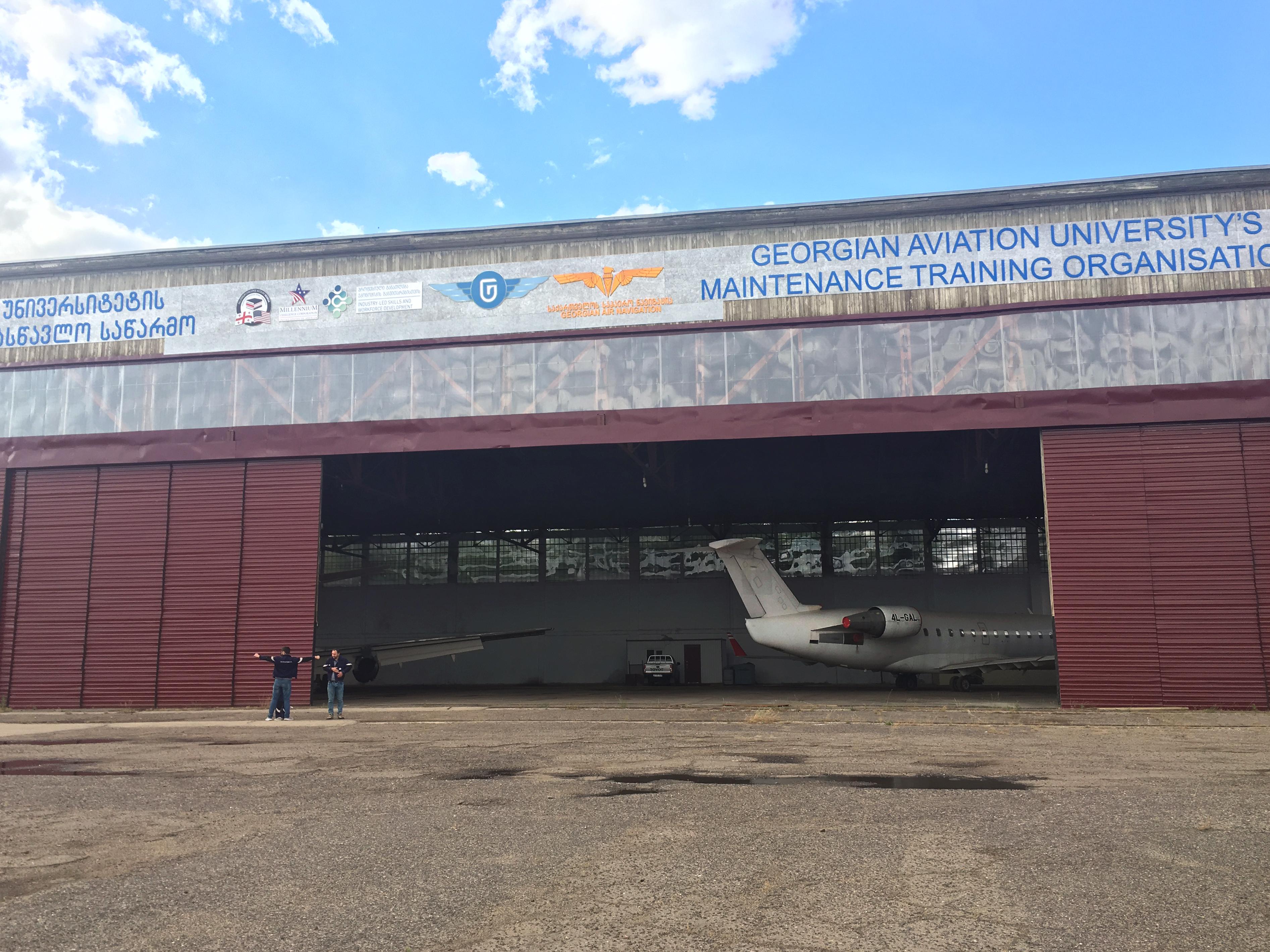 Picture of an aircraft hangar with open doors and the rear of a plane in Kakheti region owned by the Georgian Aviation University, a PICG grant recipient
