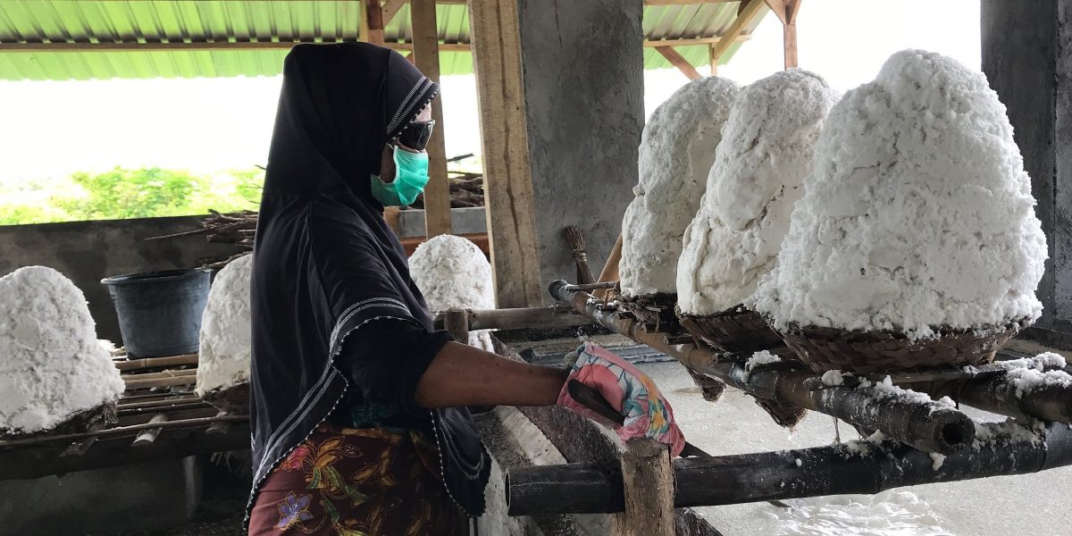 A salt producer drains harvested salt in Lombok, Indonesia. Salt-making is a labor-intensive process that relies on the availability of briny water and the heat of the sun to achieve evaporation, concentration and crystallization. MCC’s investments are helping to introduce technologies that are enabling Lombok’s sea salt producers to make higher-quality, higher-priced salt year around.