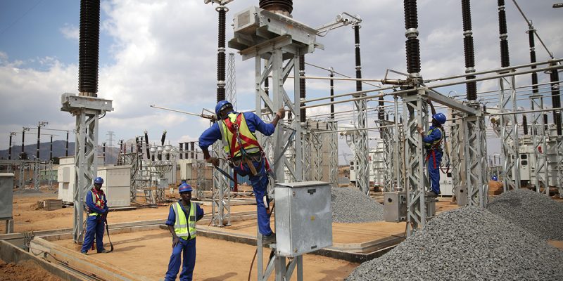 Workers on power equipment in Malawi