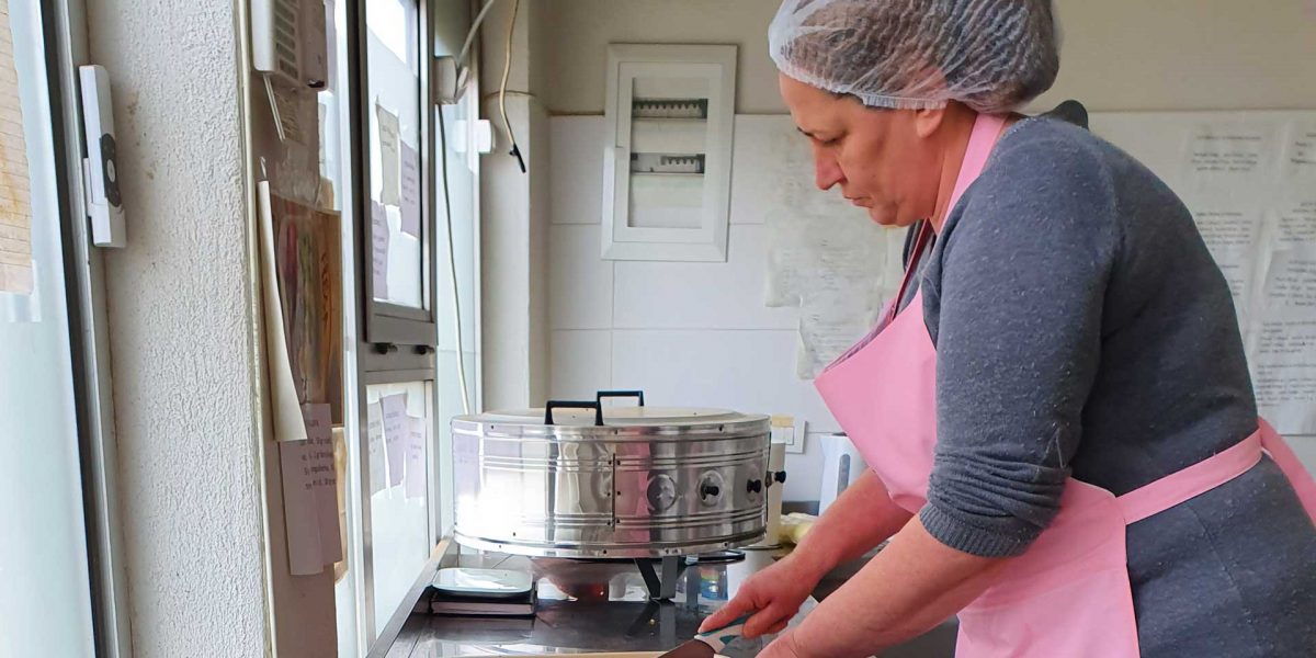 A woman Fresa employee in Kosovo preparing food.