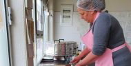 A woman Fresa employee in Kosovo preparing food.