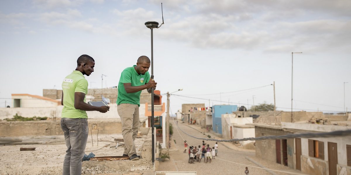 Technicians Ismael Rodrigues (left) and Jose Silva (right) work to survey and geomap a property on the island of Maio as part of the MCC-Cabo Verde Compact. Accurate information about land rights and ownership is important to facilitating private investment in Cabo Verde, where tourism is a major driver of the economy.