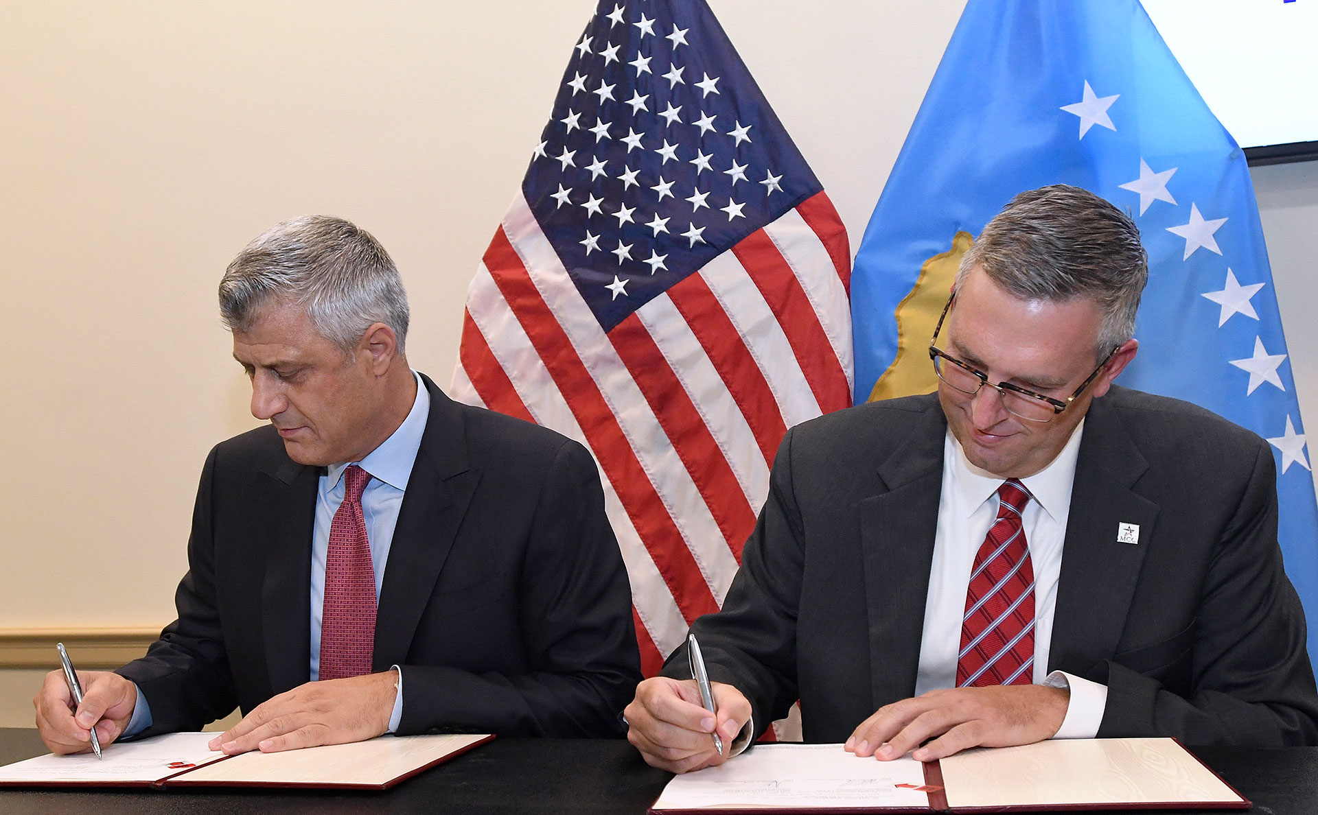 Kosovo President Hashim Thaci, left, and Jonathan Nash, acting CEO of Millennium Challenge Corporation, sign the Kosovo Threshold Program, Tuesday, Sept. 12, 2017 in Washington, D.C.