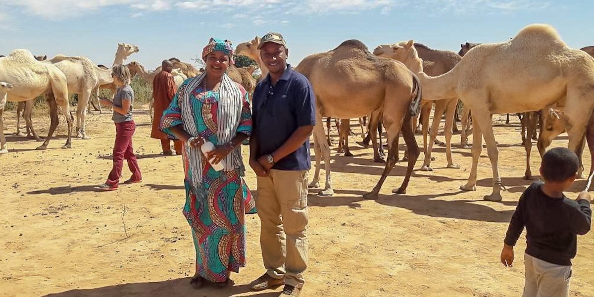 Entrepreneur Wouro Habsatou Aboubacar (left) and MCC Administrative Assistant Abderahamane Diallo (right) pose at Habsatou’s camel ranch near the Youri village in Niger. Habsatou is a potential beneficiary of MCC’s Niger Compact.
