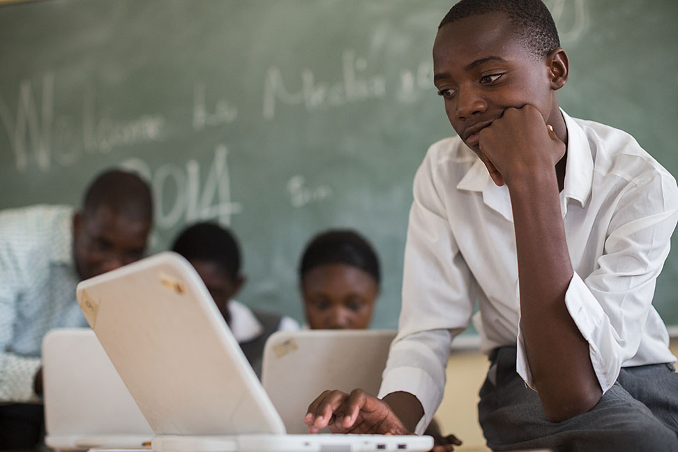 Photo: A boy works on a laptop at school in Namibia.