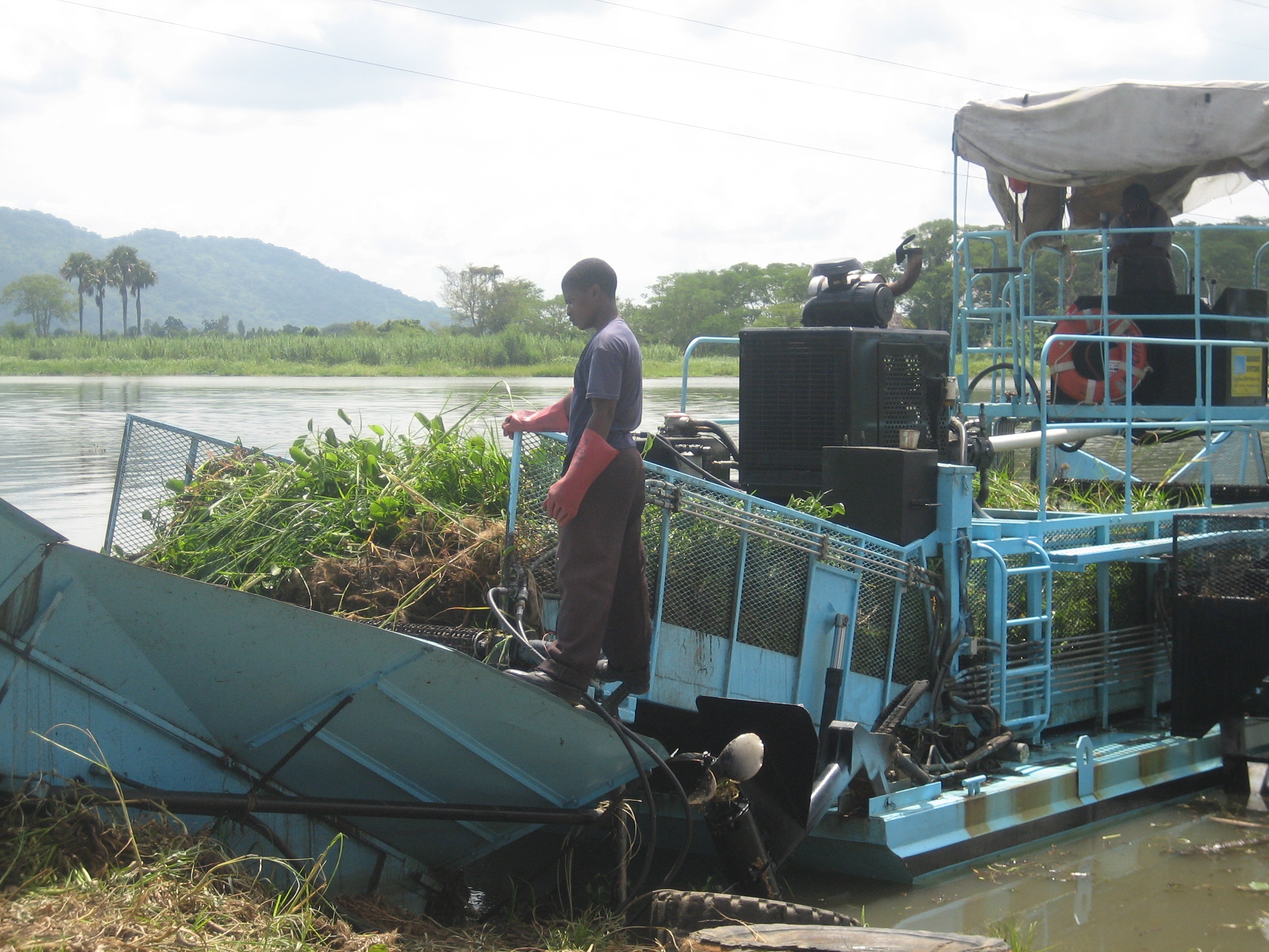 A two-man crew operates a weed harvester on the Shire River in Malawi to keep the hydroelectric plant from being damaged by over growth.